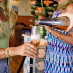 Wine attendant pouring glass of rose