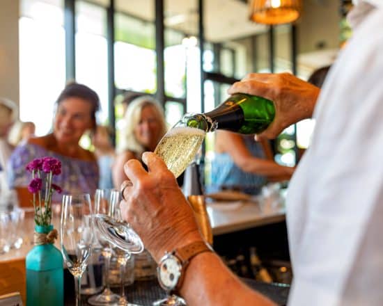Wine attendant pouring champagne